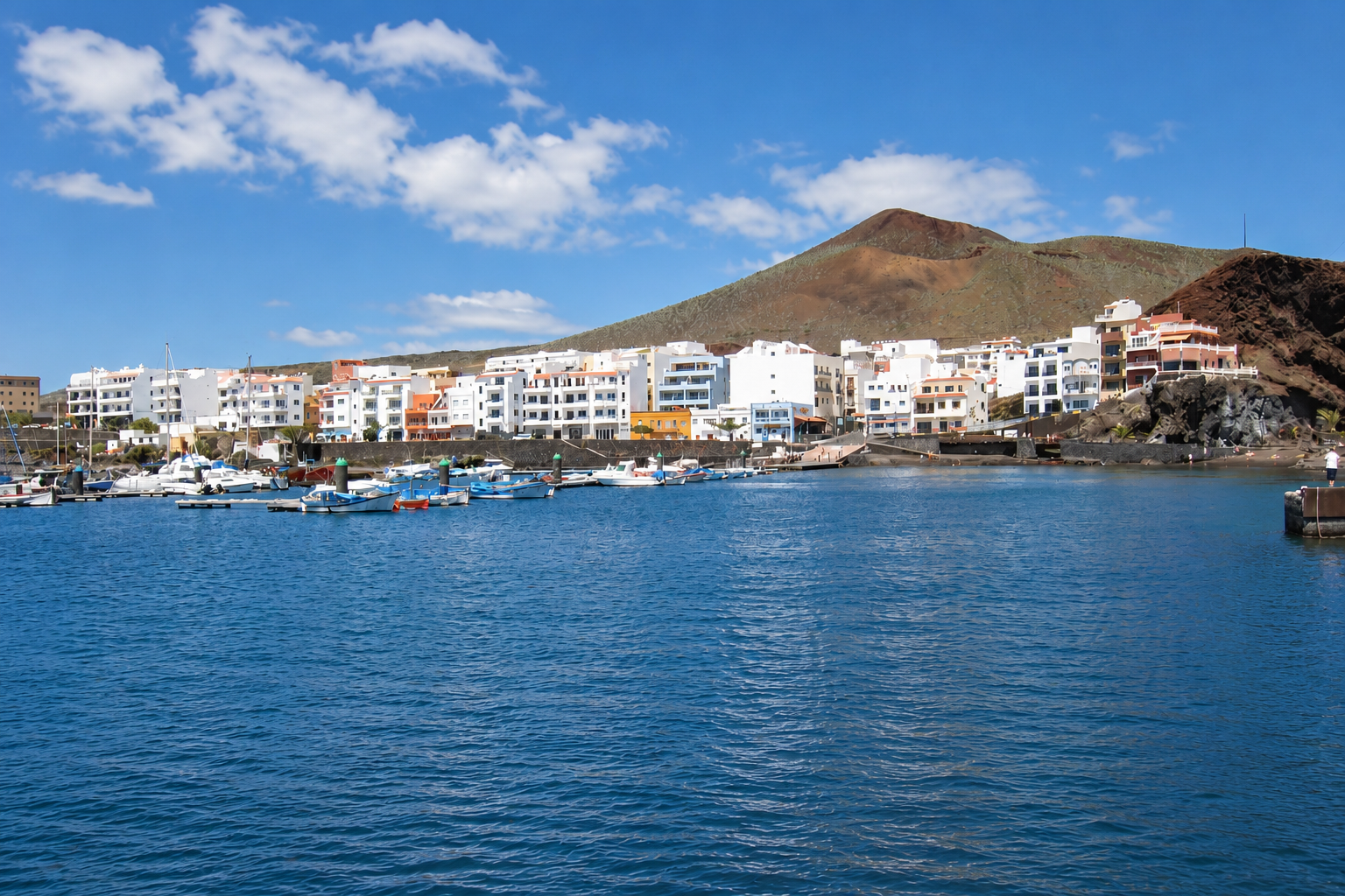 Vista panorámica de La Restinga, un pueblo pesquero de El Hierro con su puerto deportivo y el paisaje volcánico al fondo
